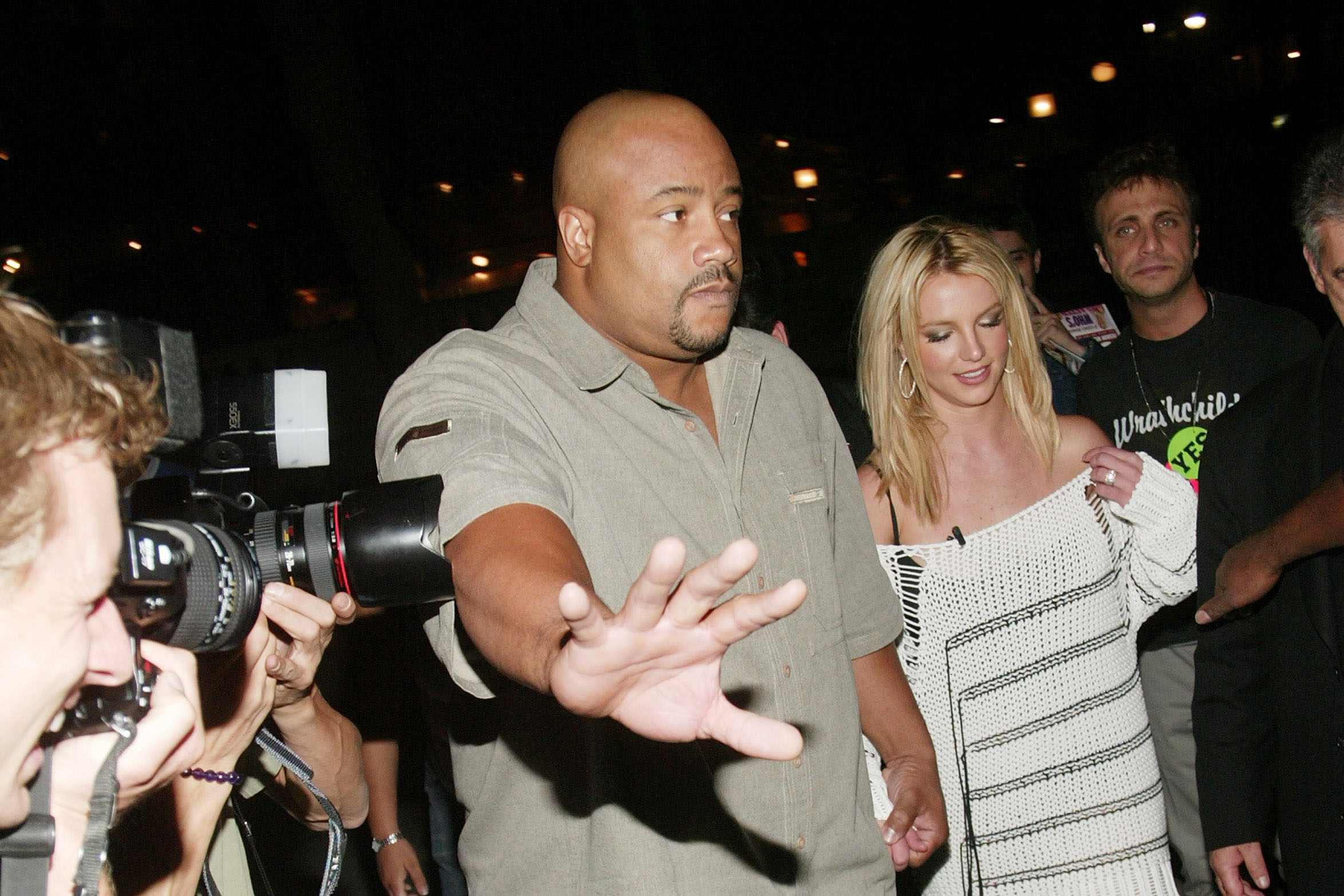 Britney Spears braves a crowd of press photographers in 2003