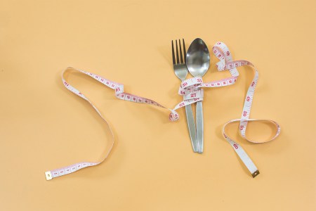 fork and spoon with a tape measure