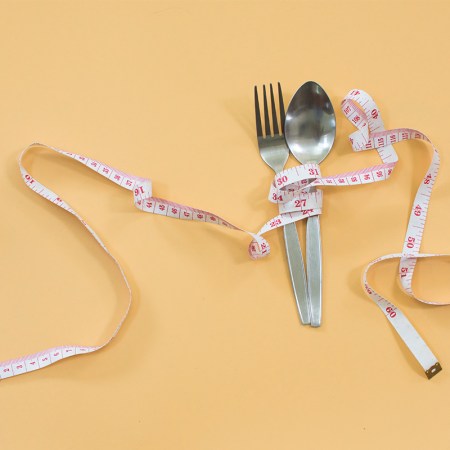 fork and spoon with a tape measure