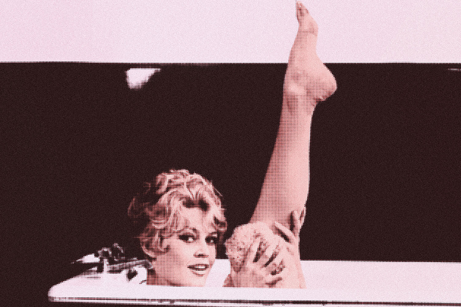 Brigitte Bardot holding up leg in bathtub