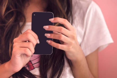 young woman holding phone