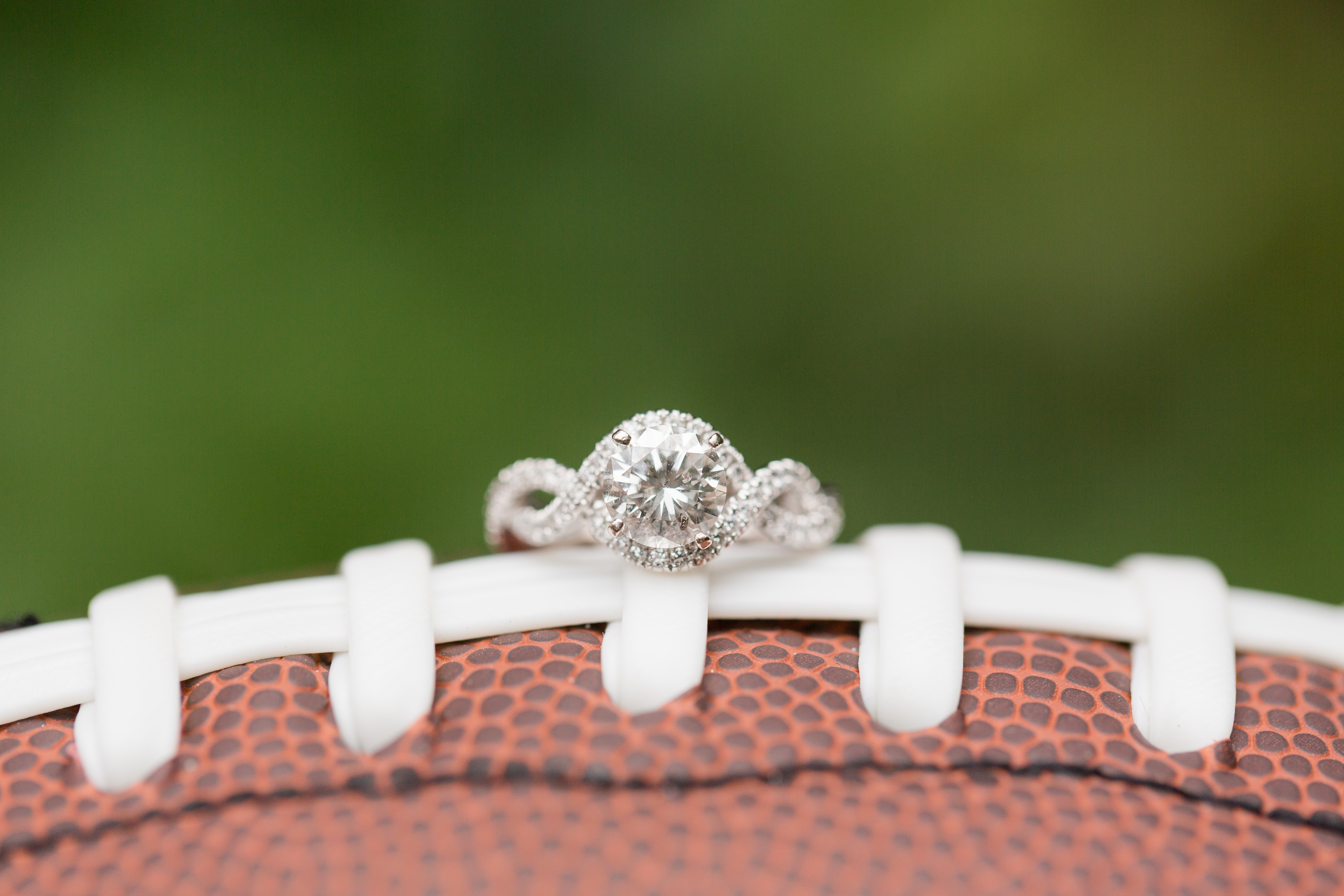 engagement ring resting on football
