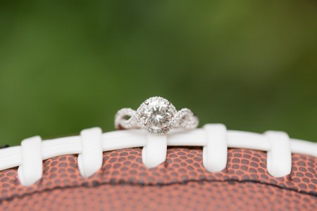 engagement ring resting on football
