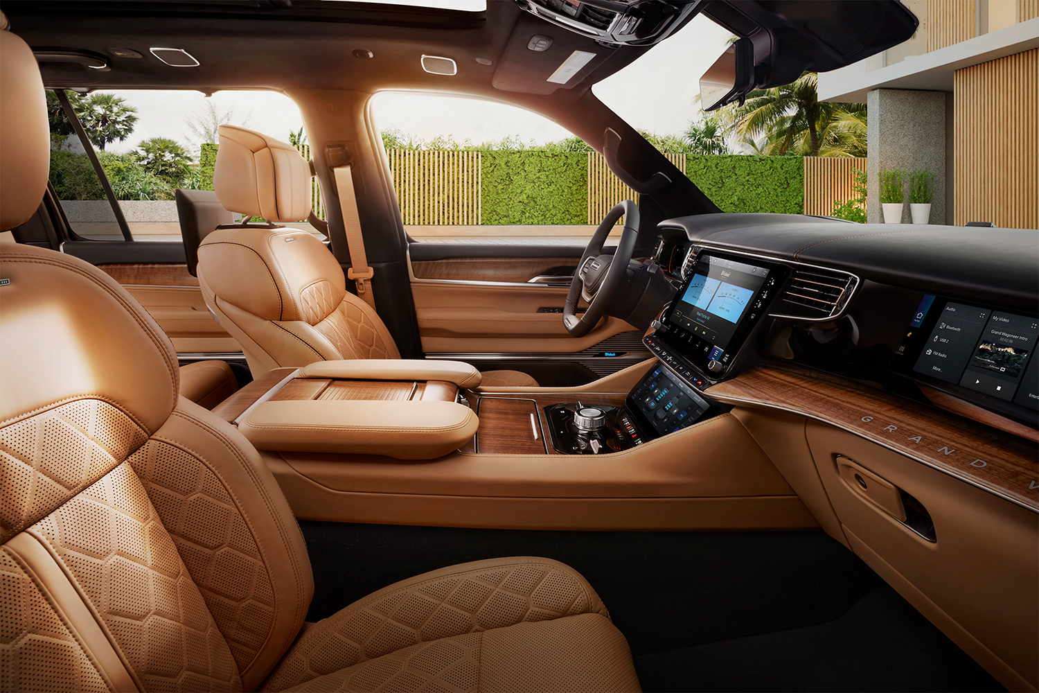The leather and wood accented interior of the 2022 Jeep Grand Wagoneer shot from the passenger seat