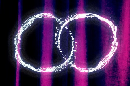 two white rings intersecting over a purple background