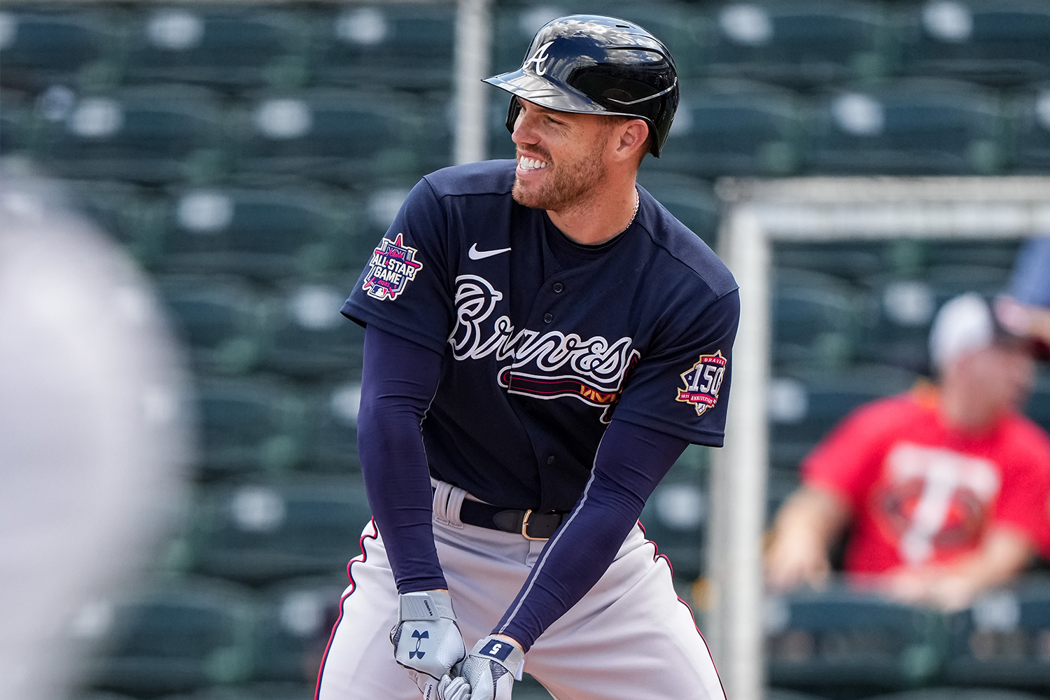 Freddie Freeman #5 of the Atlanta Braves looks on and smiles during a spring training game against the Minnesota Twins