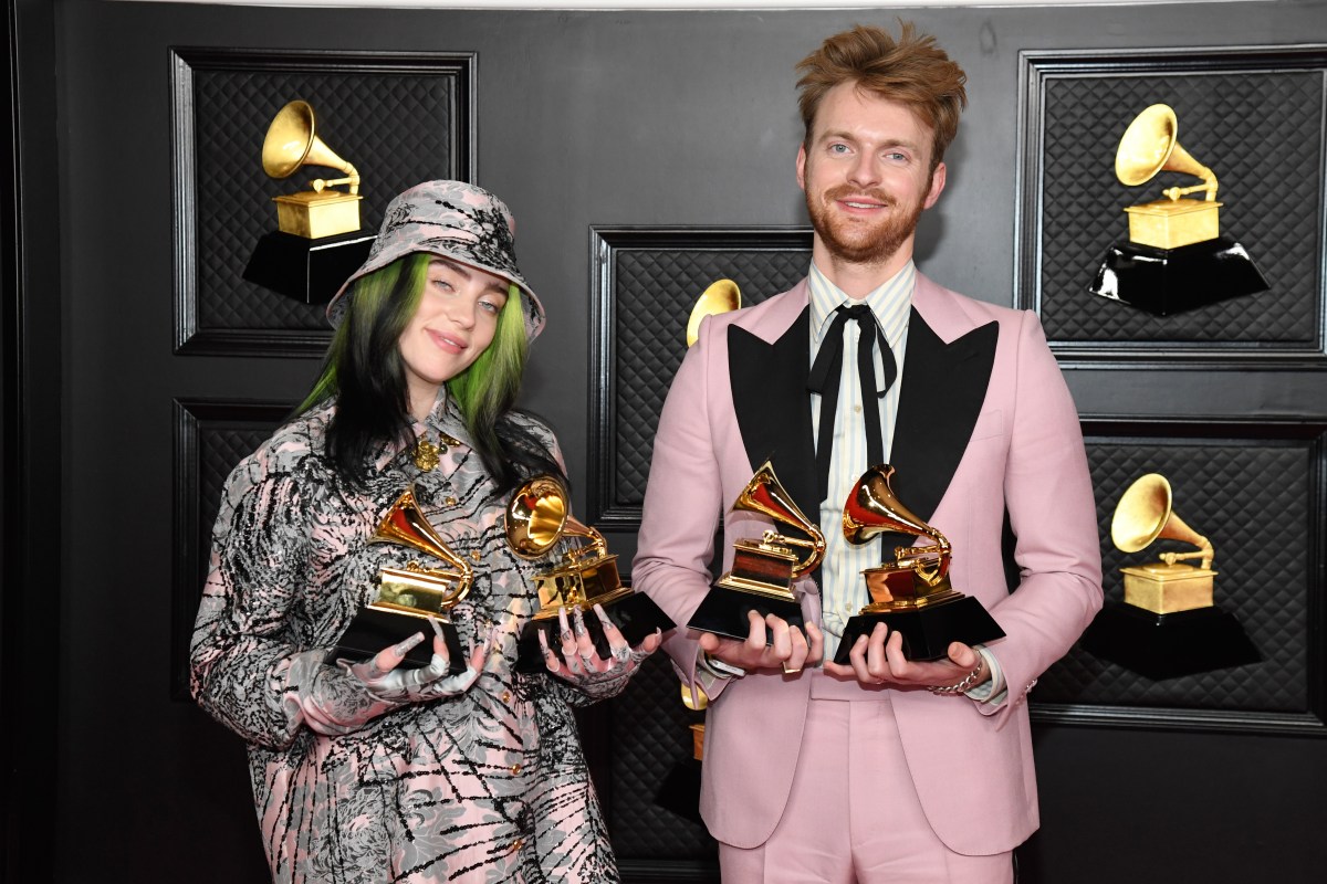 LOS ANGELE(L-R) Billie Eilish and FINNEAS, winners of Record of the Year for 'Everything I Wanted' and Best Song Written For Visual Media for "No Time To Die", pose in the media room during the 63rd Annual GRAMMY Awards at Los Angeles Convention Center on March 14, 2021 in Los Angeles, California.