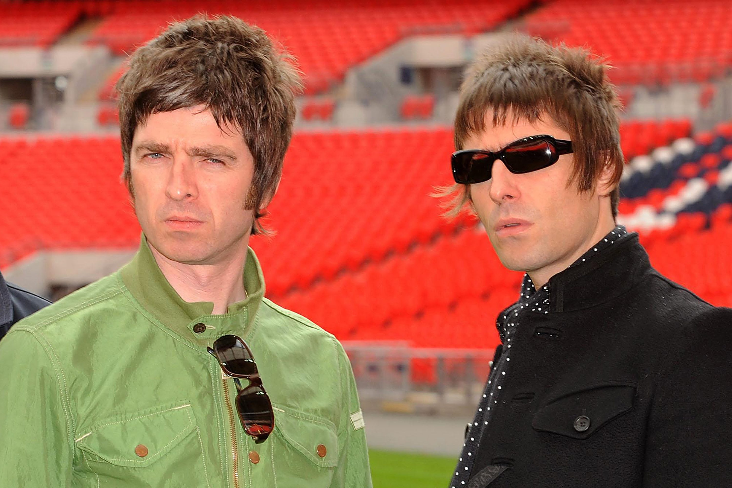 Noel Gallagher (left) and Liam Gallagher of Oasis pose at Wembley Stadium on October 16, 2008 in London, England.