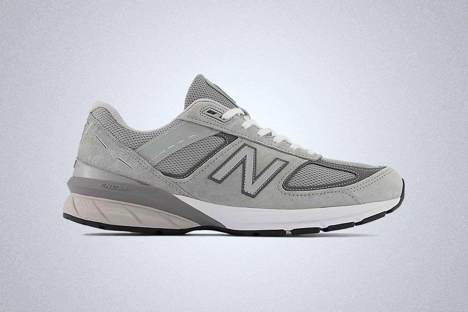 a grey New Balance 990v5 sneaker on a grey background