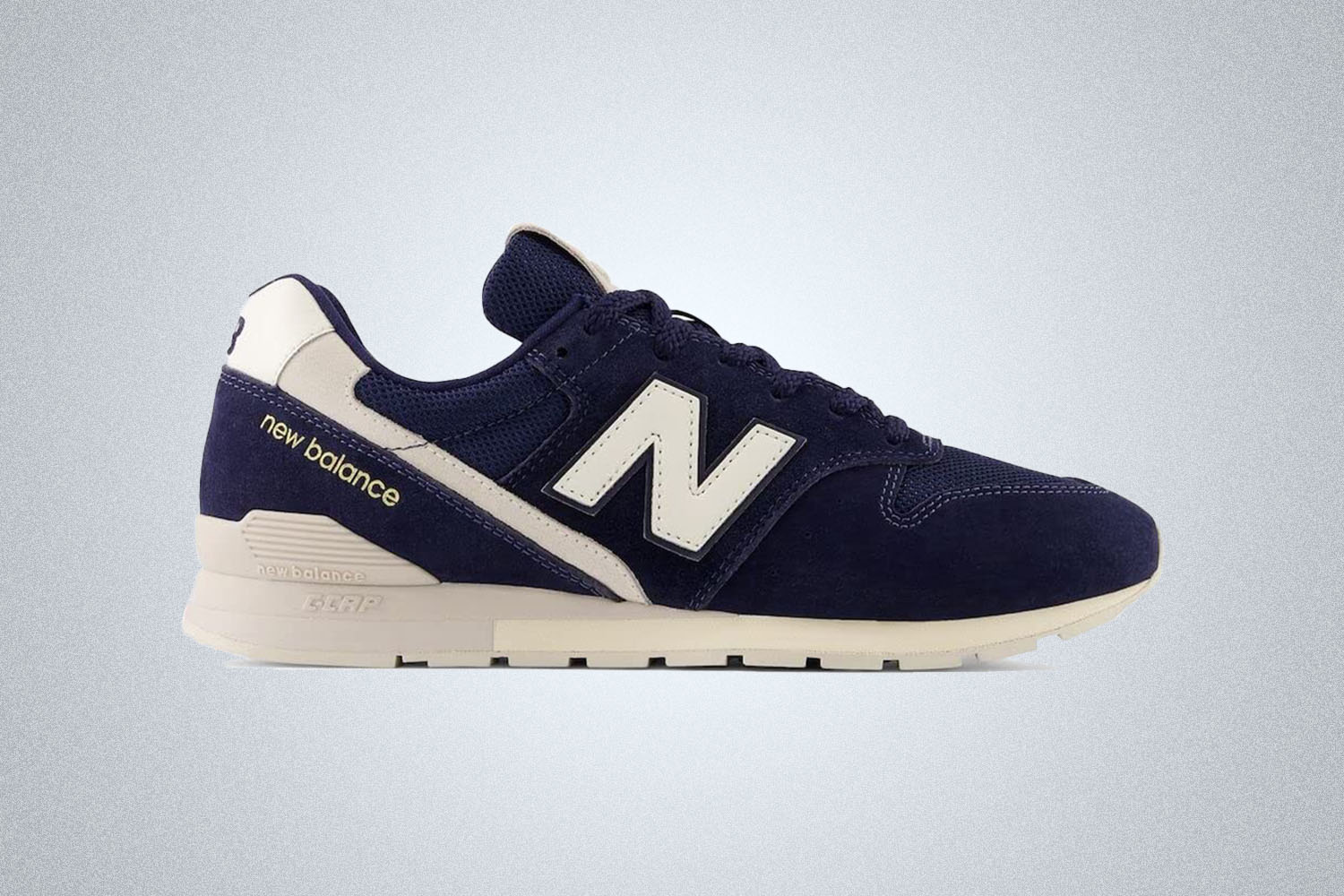 a New Balance 996 sneaker in navy on a grey background
