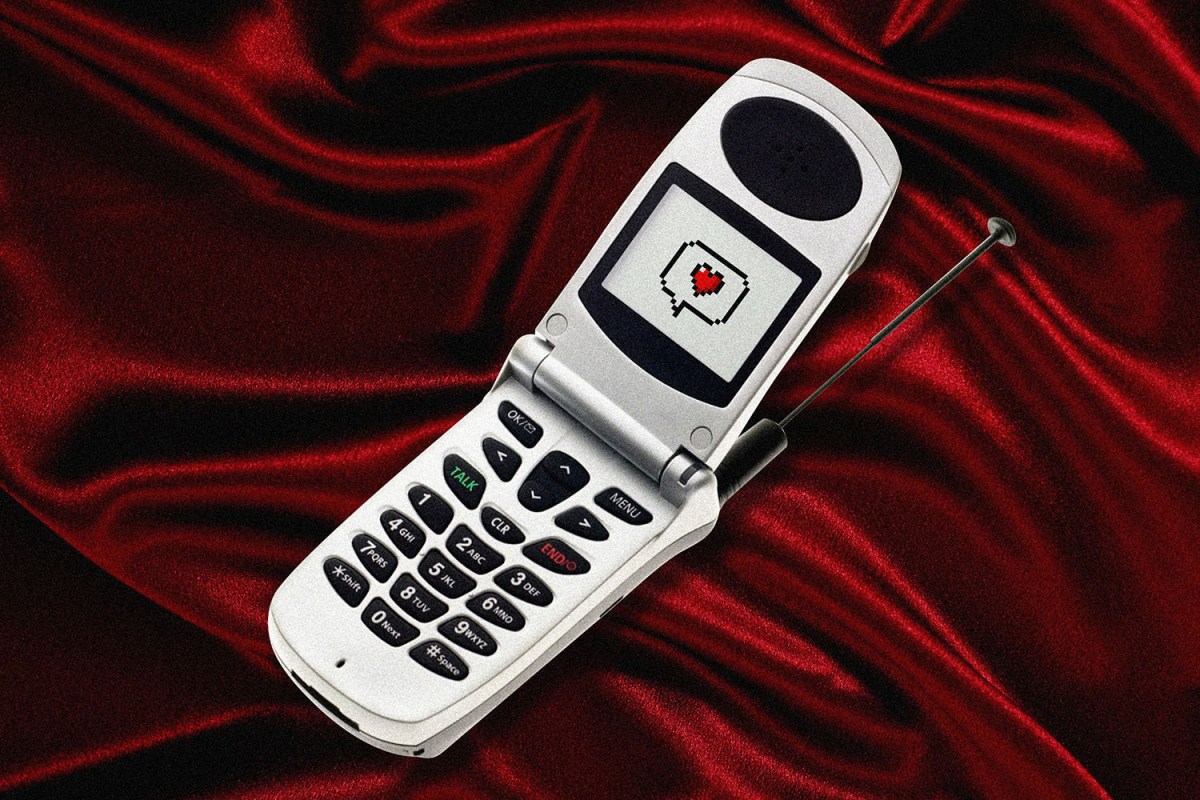 Flip phone on a red velvet background with an 8 bit heart on the screen.