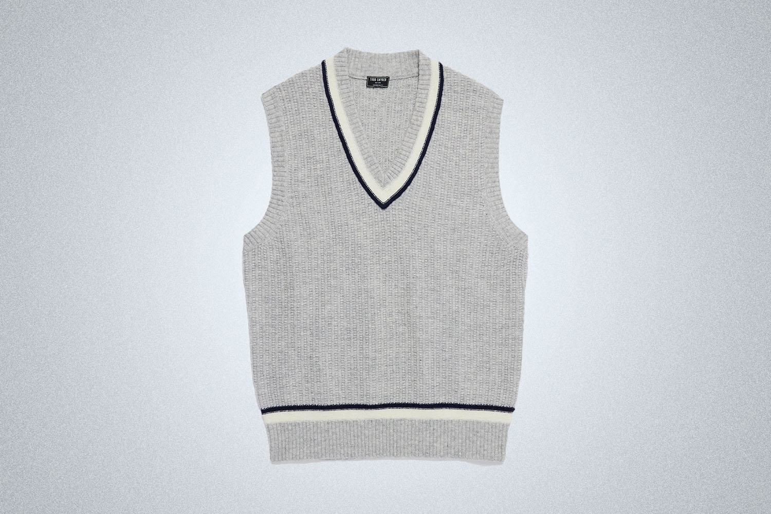 a sweater vest on a grey background