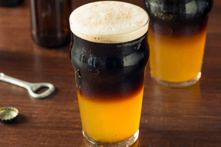 Irish Layered Black and Tan Beer with Lager and Stout in a glass on a bar