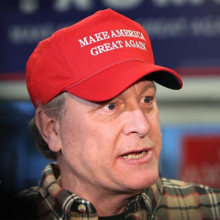 Former Boston Red Sox pitcher Curt Schilling in a red Make America Great Again hat