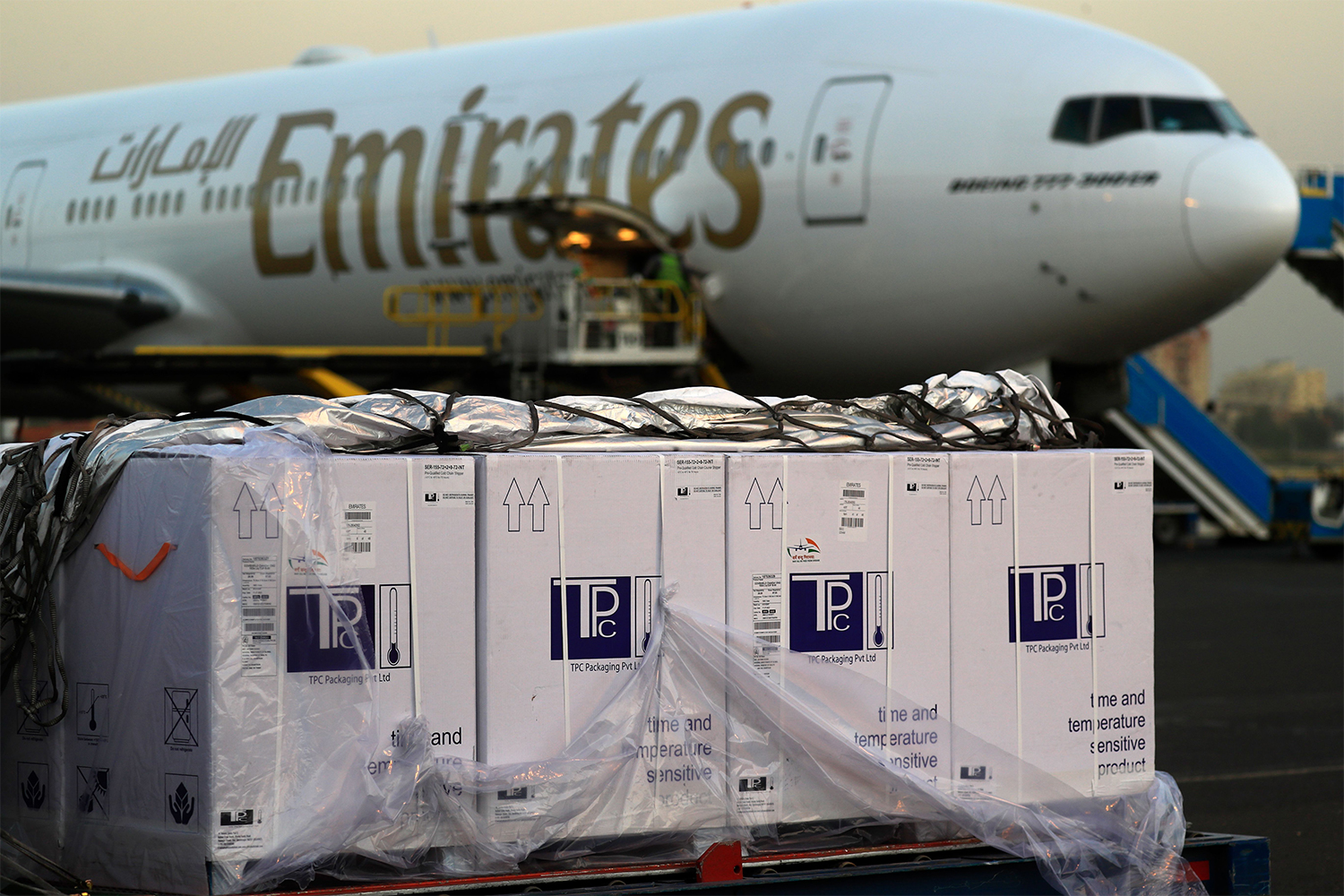 Boxes of coronavirus vaccines are stacked on the tarmac after the first batch arrived at Khartoum airport in the Sudanese capital in an Emirates plane, on March 3, 2021
