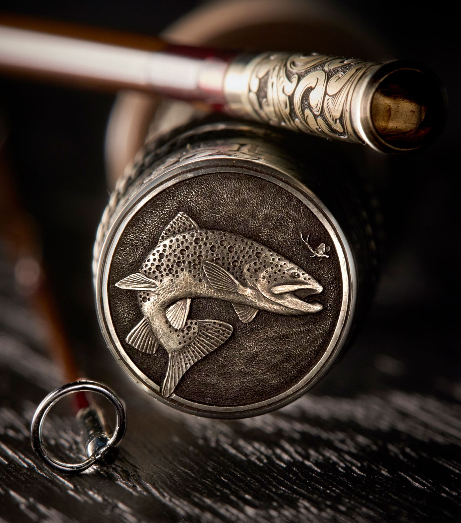 The end of a custom fly fishing rod from Bill Oyster engraved with a fish