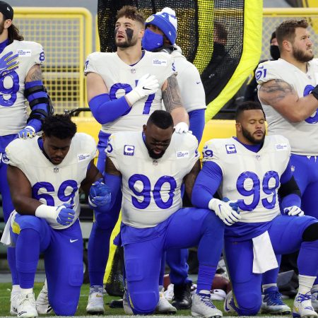 Members of the Los Angeles Rams kneel during the national anthem