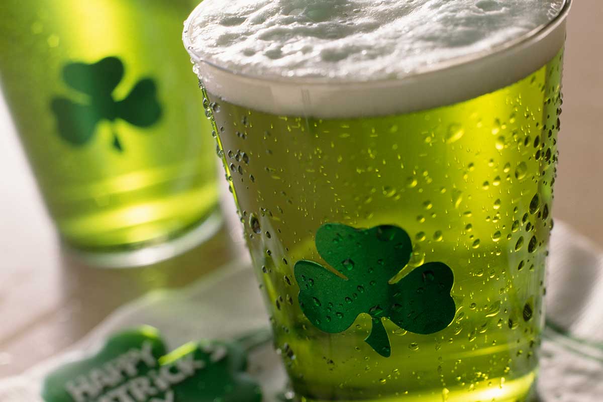 A close-up of shamrock glasses with green bar on St. Patrick's Day