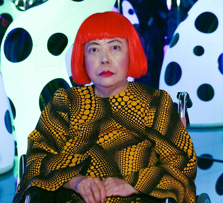 Artist Yayoi Kusama wearing her signature bright red wig