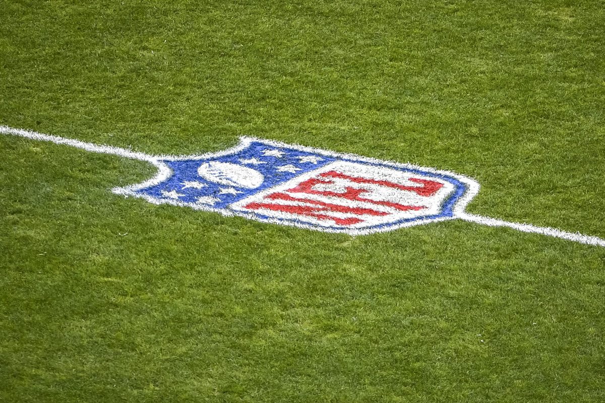 The NFL logo on the field.