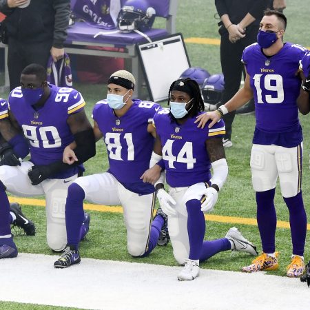 Vikings players kneel during the national anthem