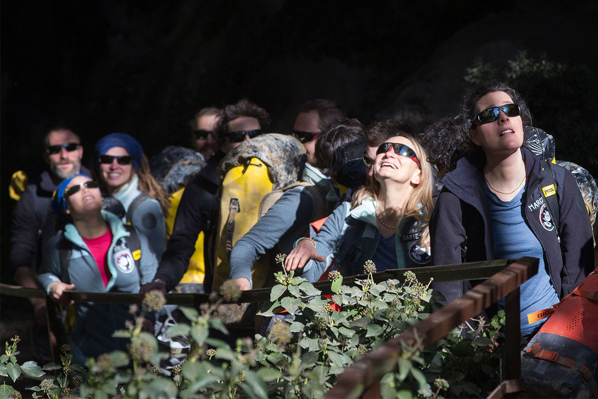 Volunteers with sunglasses on emerge from the Deep Time experiment in a French cave