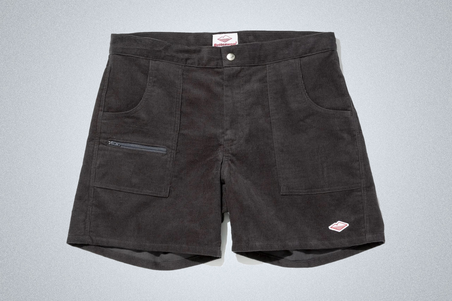 a pair of grey Battenwear corduroy shorts on a grey background