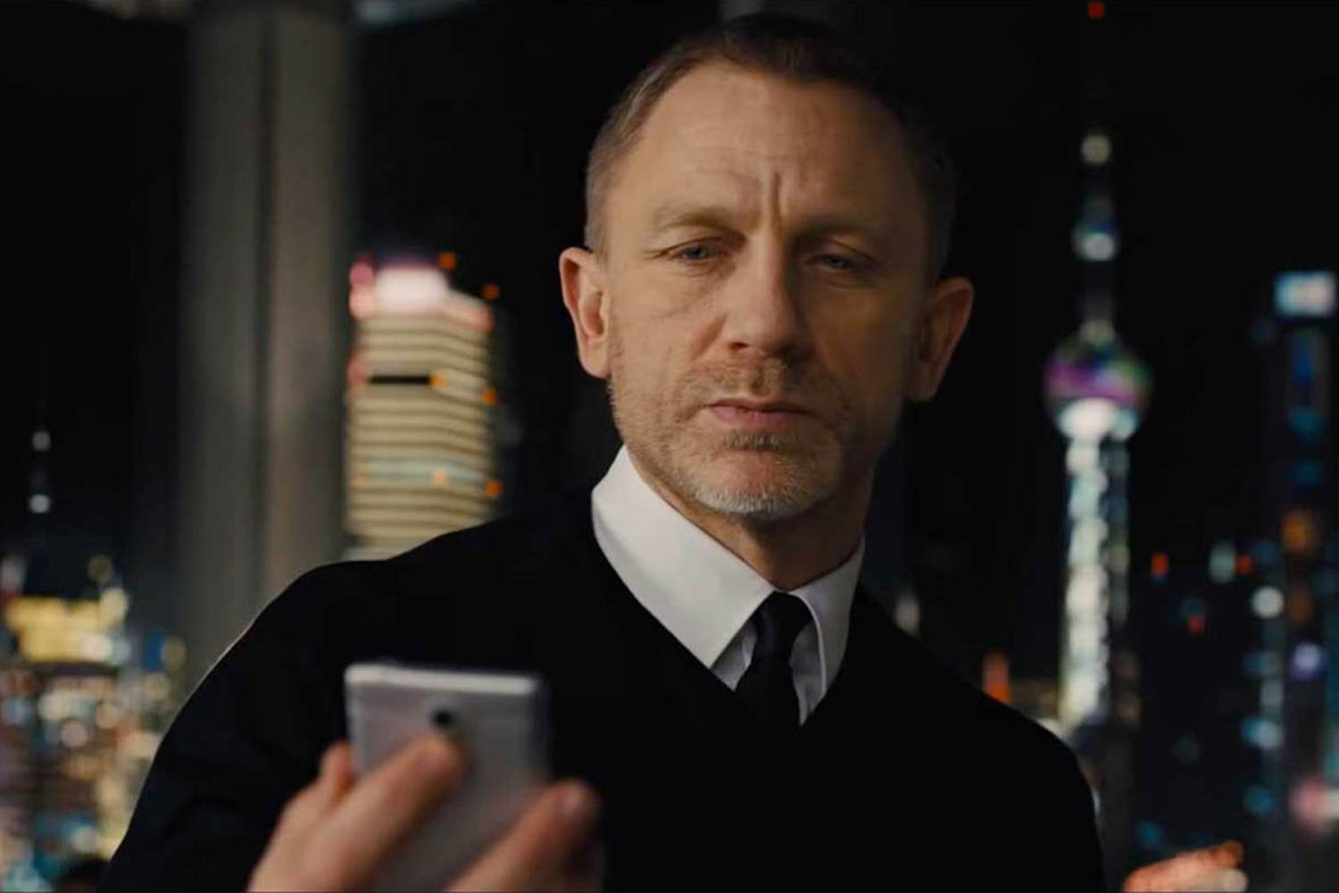 Daniel Craig as James Bond looking at a phone in 2012's "Skyfall"