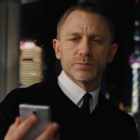 Daniel Craig as James Bond looking at a phone in 2012's "Skyfall"