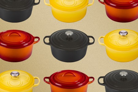 Le Creuset enameled cast iron Dutch ovens in black, orange and yellow