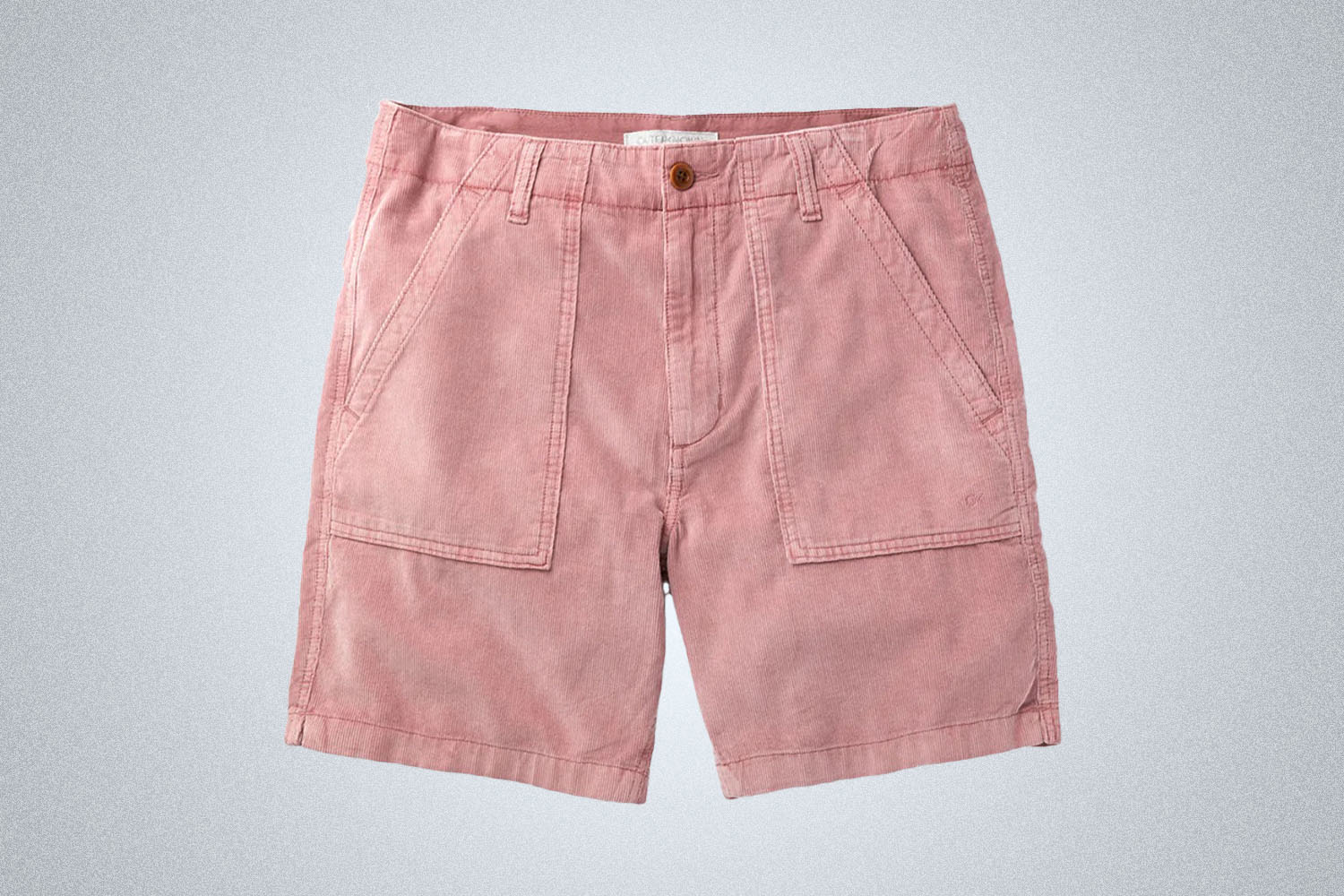 a pair of pink Outerknown corduroy shorts on a grey background