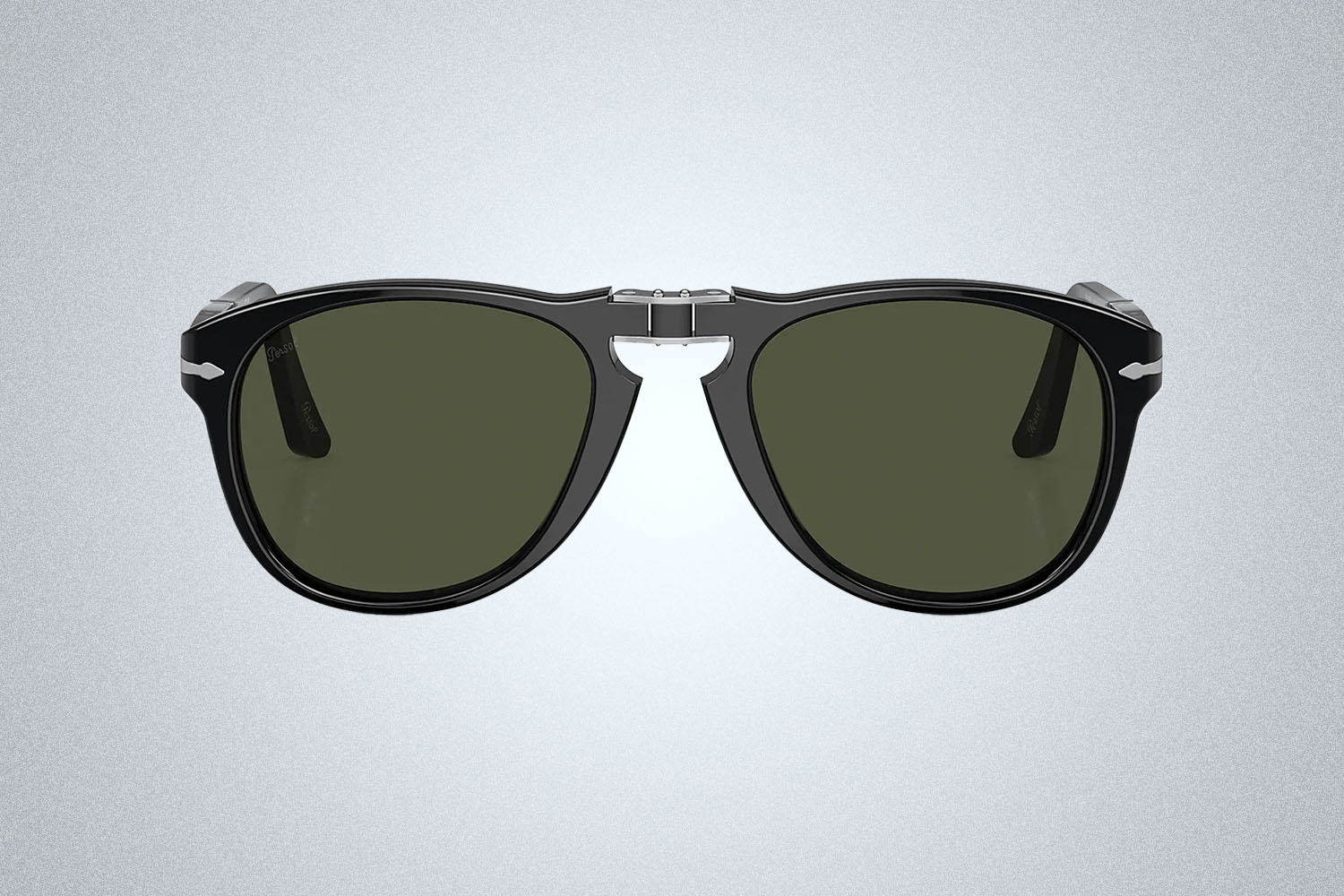 a pair of Persol sunglasses on a grey background
