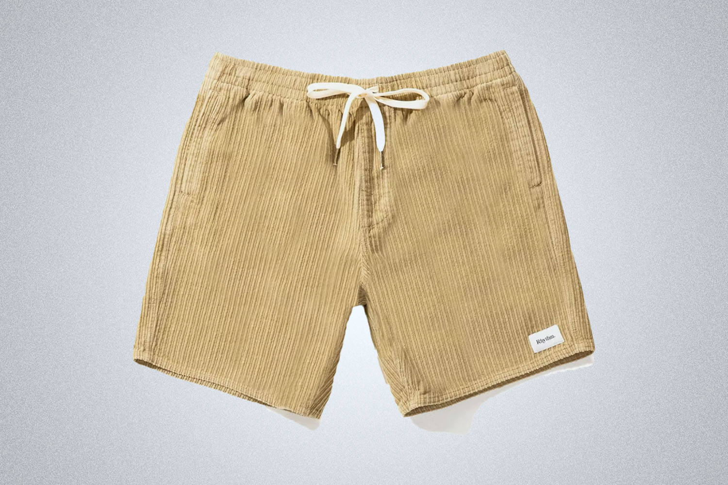 a pair of sand Rhythm corduroy shorts on a grey background