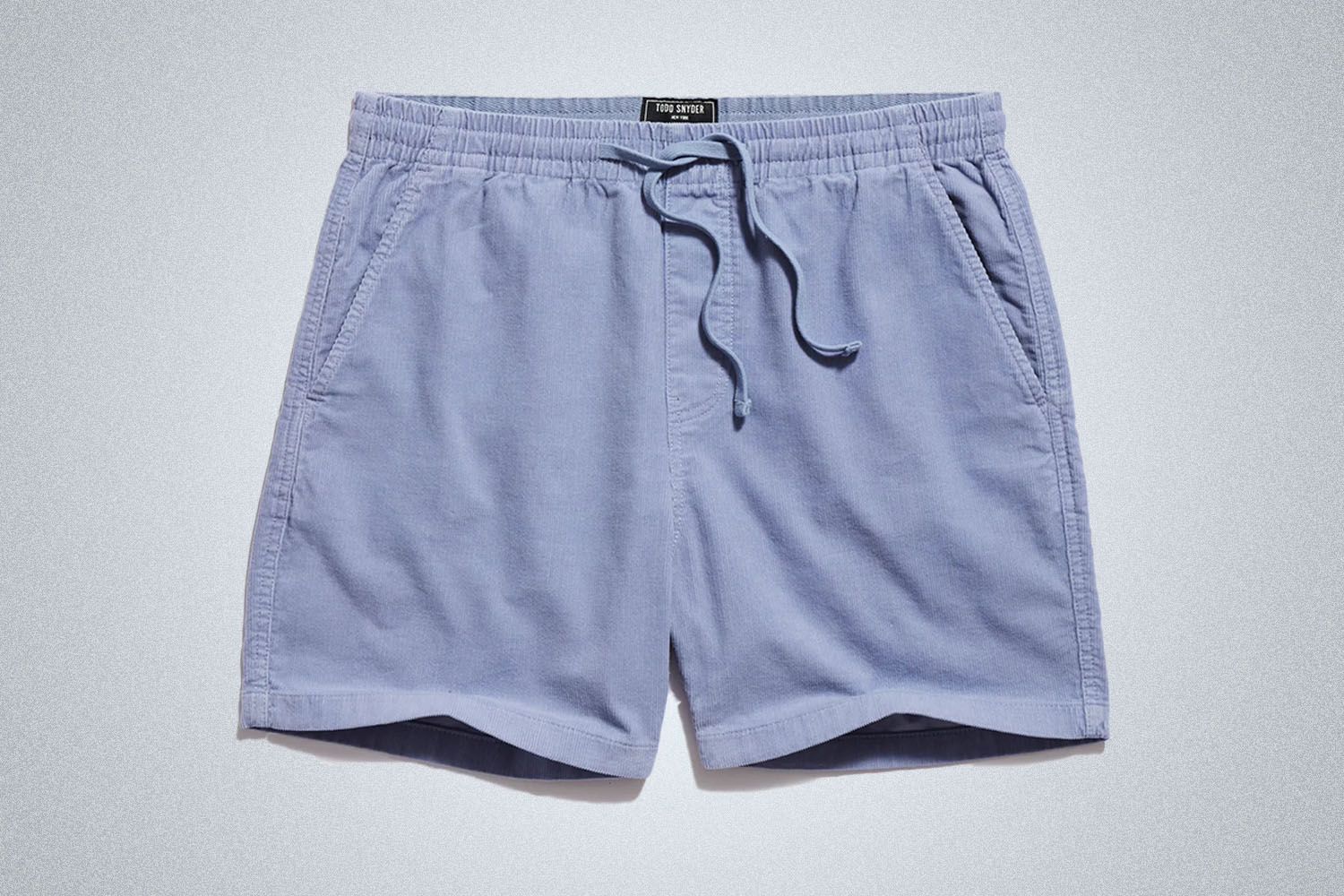 a pair of Todd Snyder corduroy shorts on a grey background