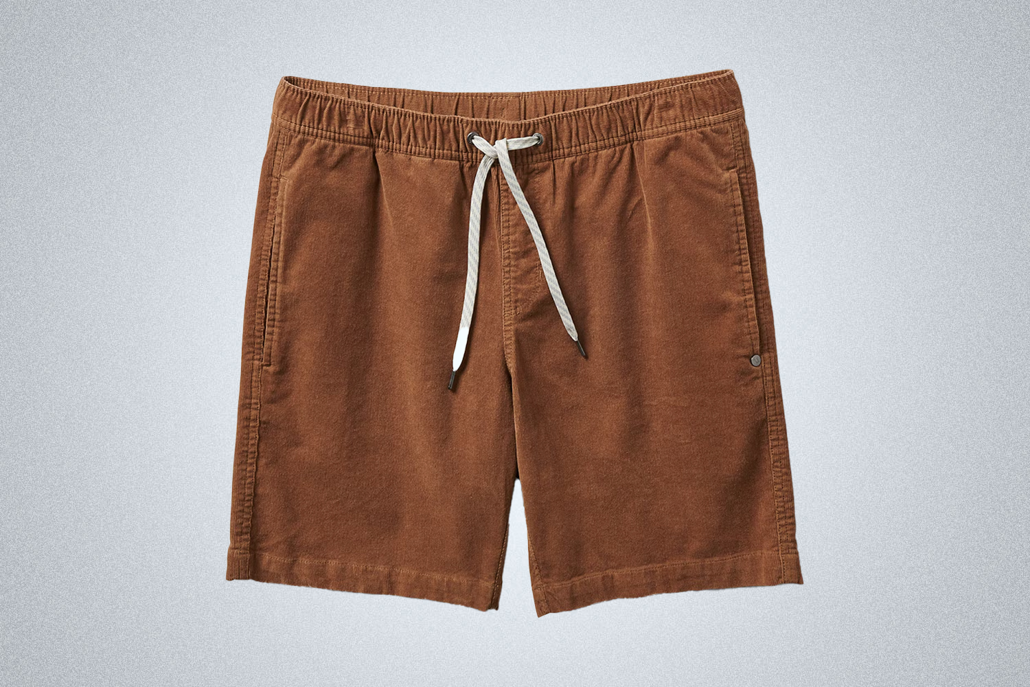 a pair of brown corduroy shorts from Vuori on a grey background