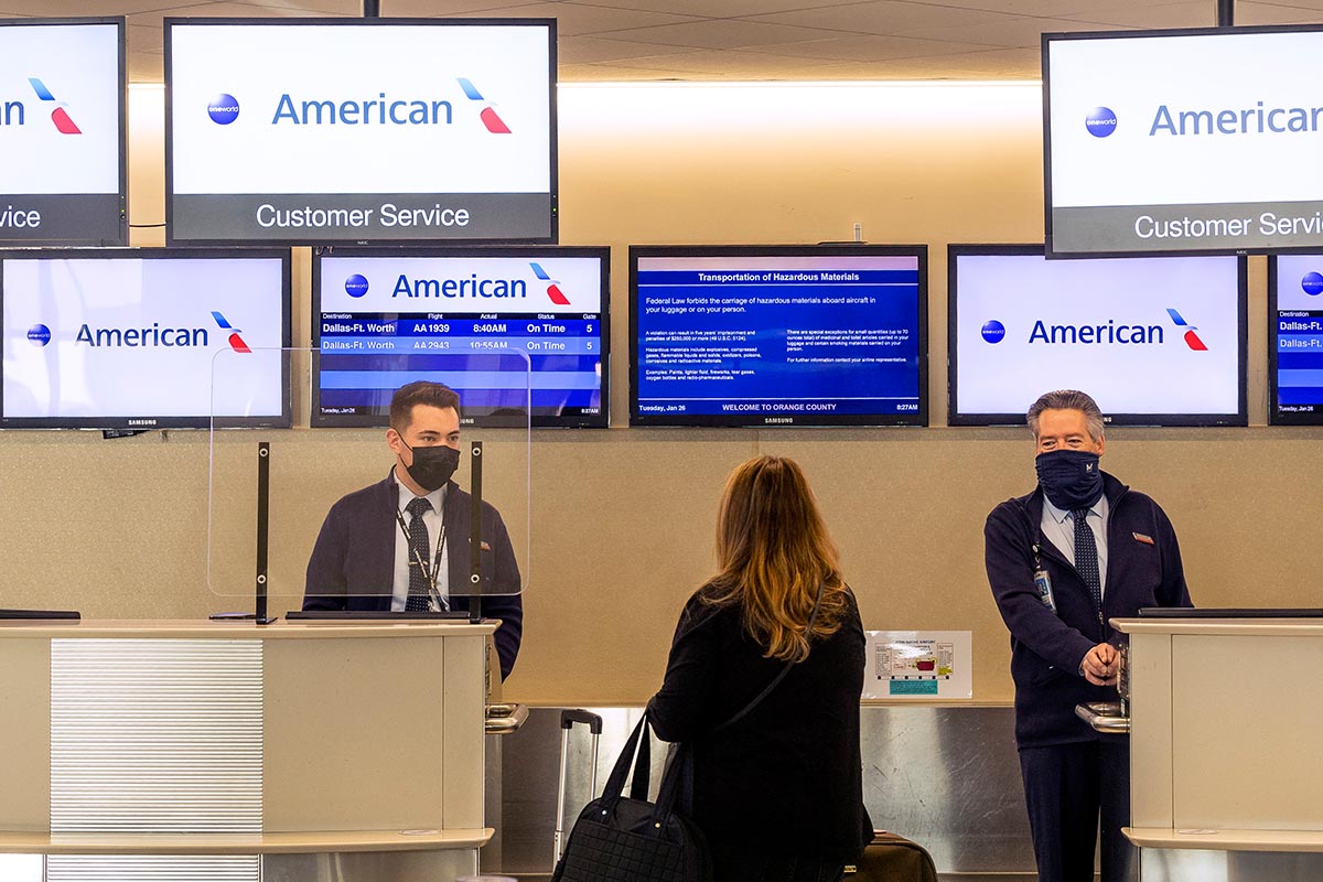American Airlines agents check in a passenger at John Wayne Airport in Santa Ana, CA on Tuesday, January 26, 2021