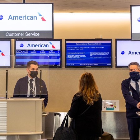 American Airlines agents check in a passenger at John Wayne Airport in Santa Ana, CA on Tuesday, January 26, 2021