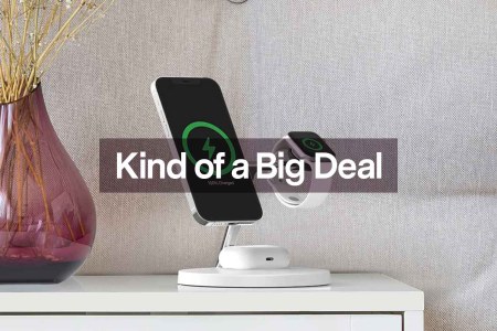 The Belkin MagSafe 3-in-1 Wireless Charger with three Apple devices charging, set on a table