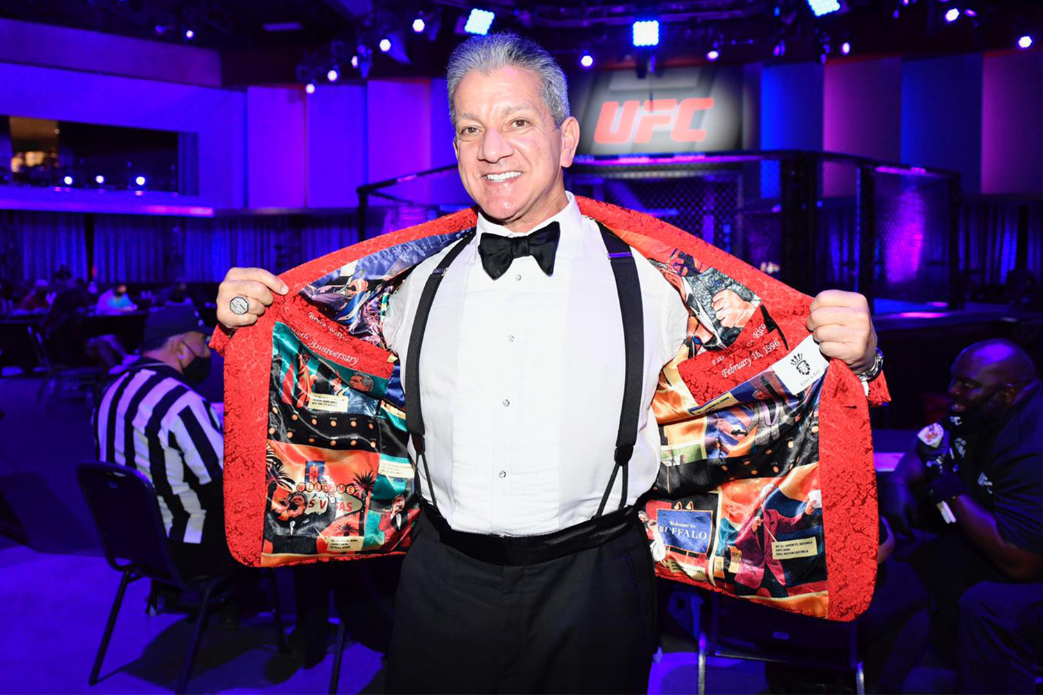 Bruce Buffer showing off the custom lining of his red smoking jacket at UFC 258