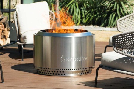 a Solo Stove fire pit in use on a back patio. The Solo Stove bundles are now on sale.