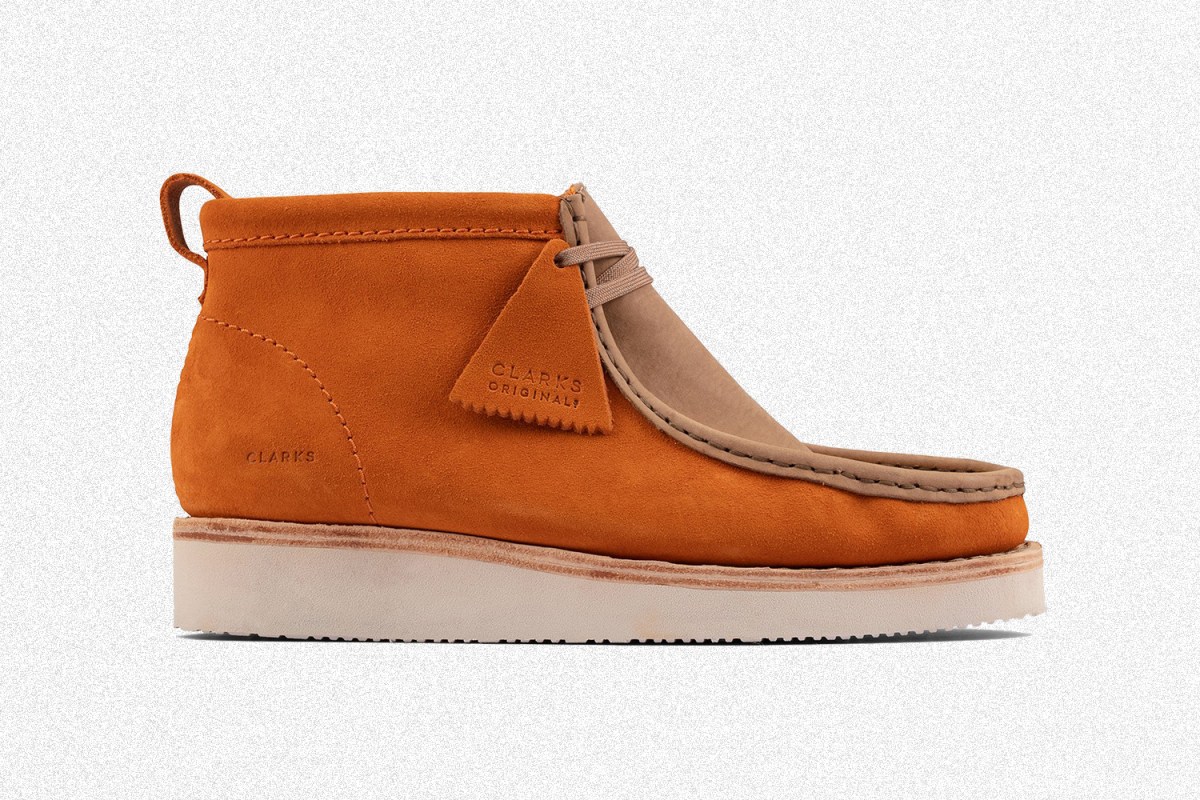 A pair of men's Clarks Wallabee Hike mocs in orange and golden tan suede