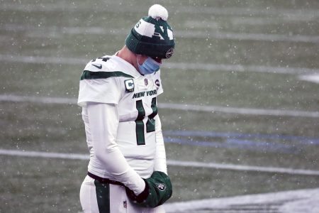 Quarterback Sam Darnold of the New York Jets wearing a face mask and beanie