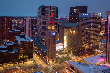 16th Street mall clock tower lit up for health care workers during Covid-19 stay at home policy. Shot with the drone.