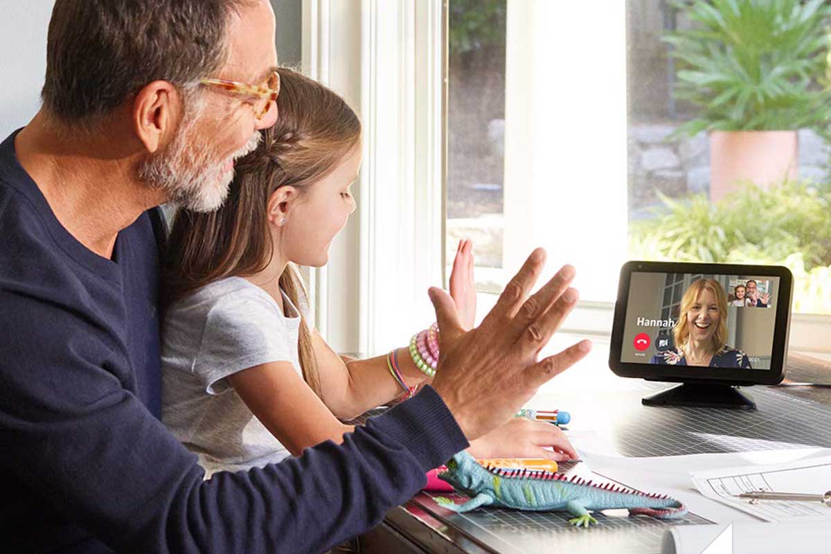 A father and daughter waving to their mom through the Amazon Echo Show 8, now on sale at Woot