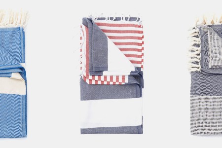 Three Turkish towels on a grey background