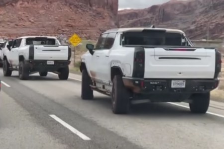 A line of Hummer EV supertrucks crab-walking on a public road