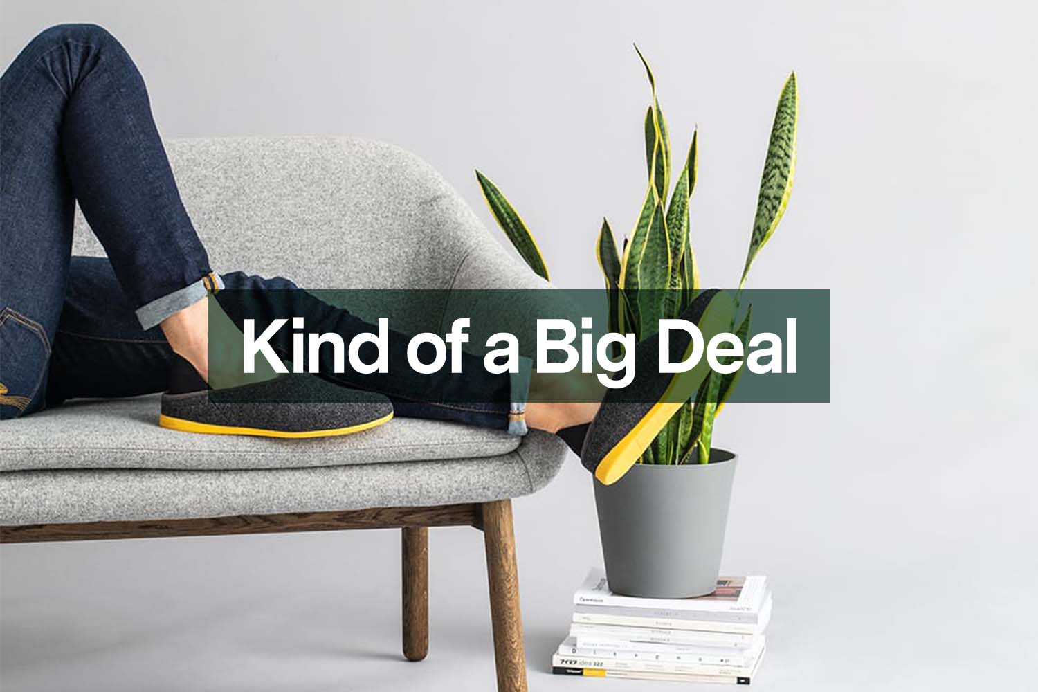 A person lying on a couch wearing mahabis slippers, now on sale at Huckberry