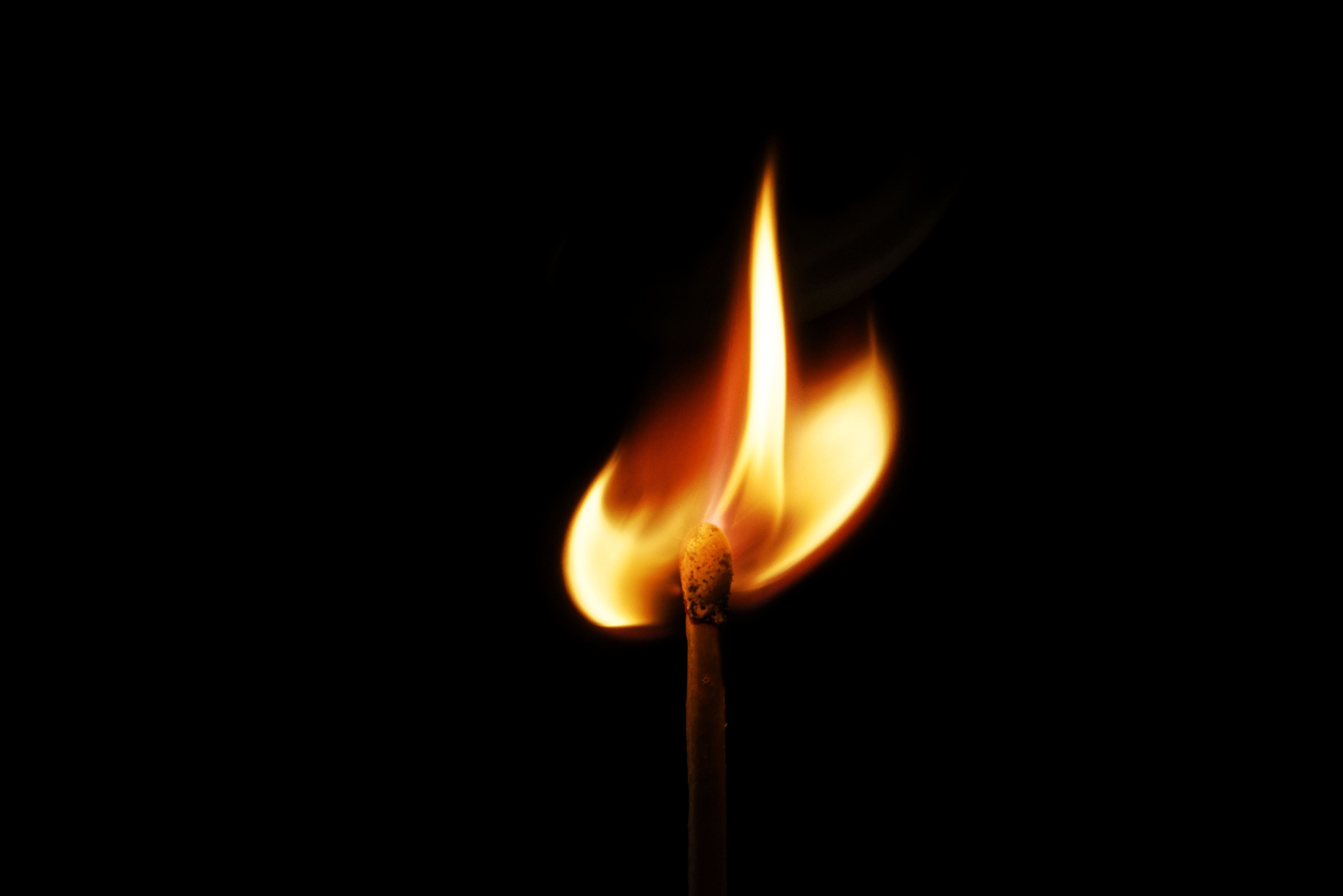 Match flame on black background