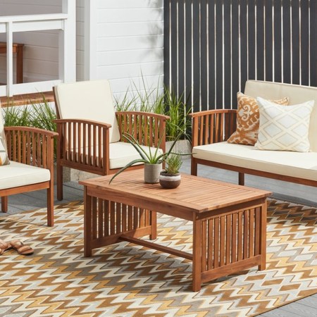 A four-piece set of Christopher Knight Home Carolina Acacia patio furniture