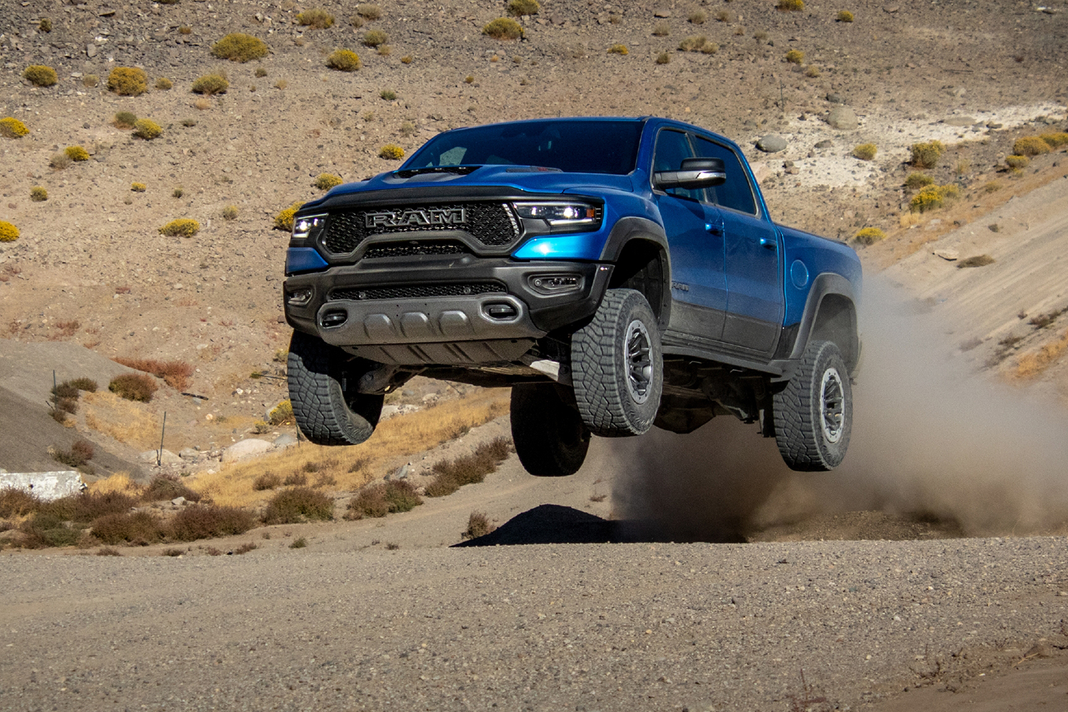 A blue 2021 Ram 1500 TRX pickup truck gets some airtime